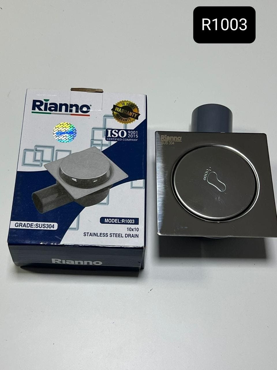 Siphon de Sol Carré à Poussoir en Inox Rianno – R1003 – Grade SUS304 (10x10 cm)